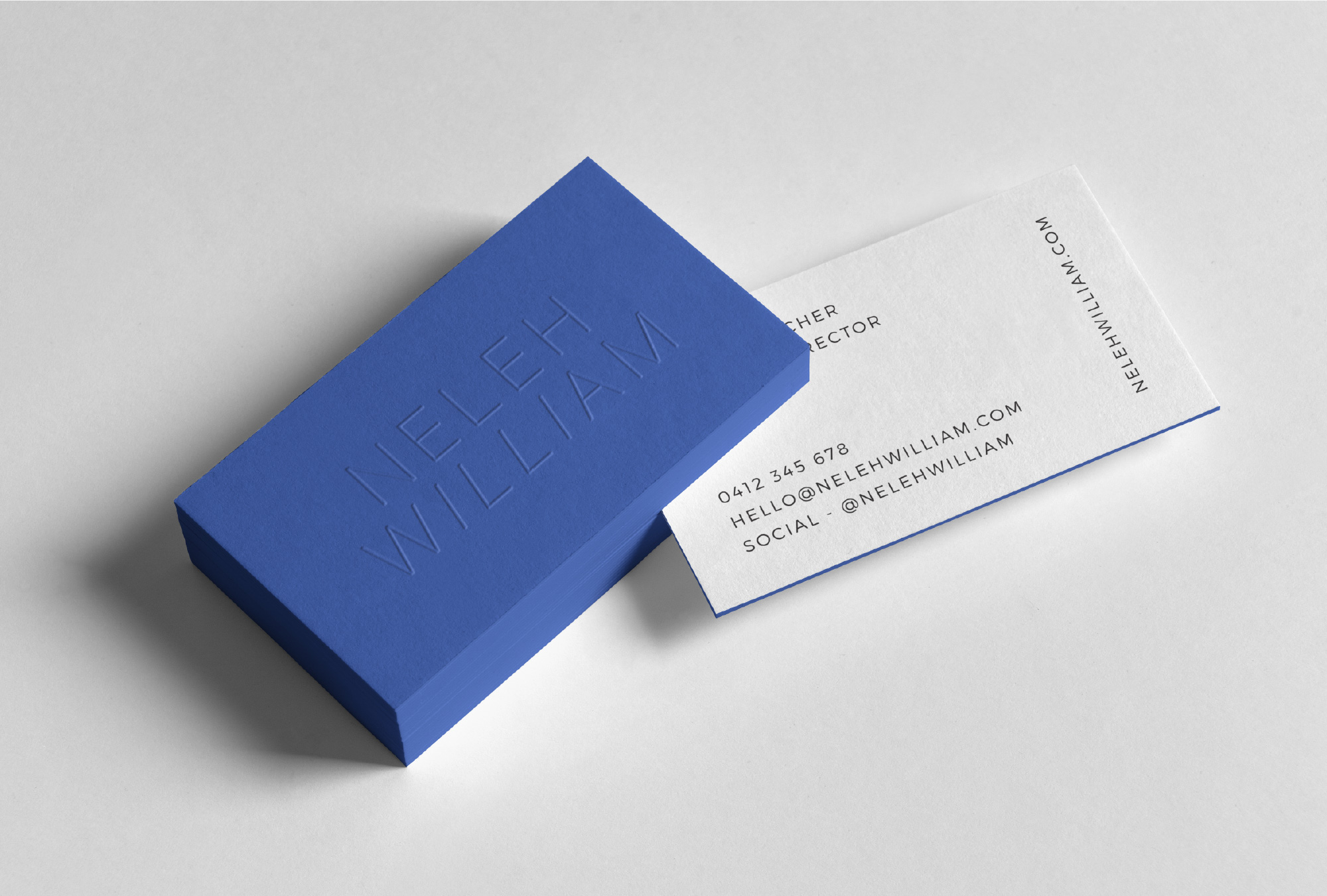 Electric blue embossed business cards for Neleh William