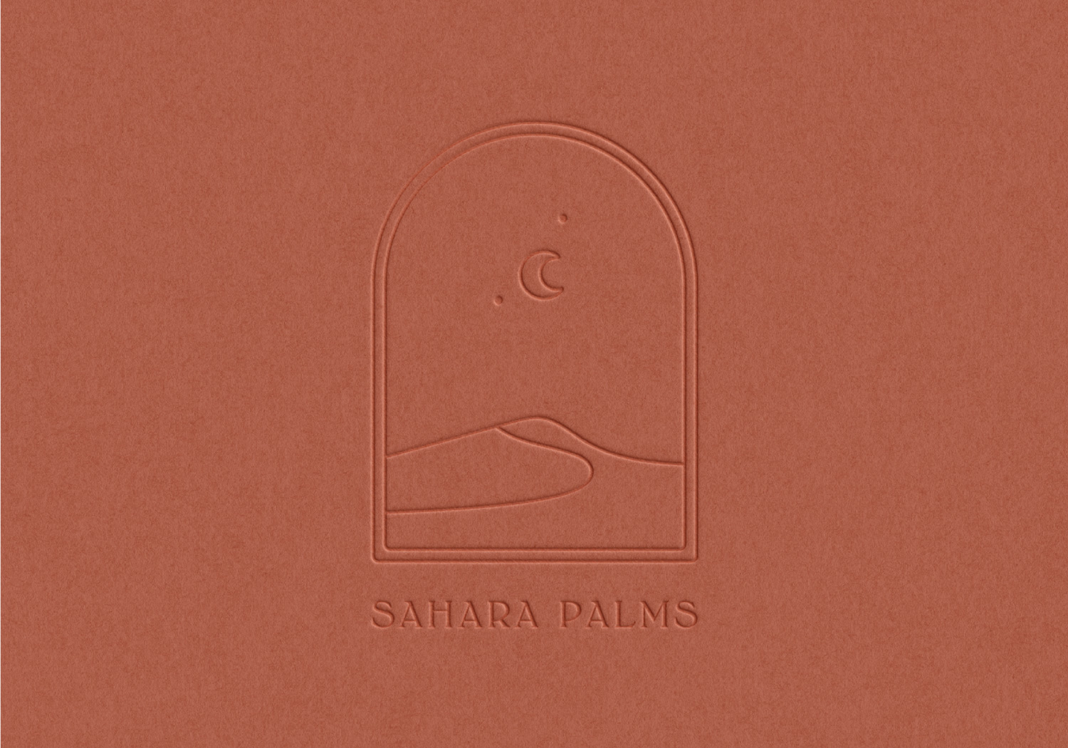 Sahara Palms logo debossed into rust coloured card