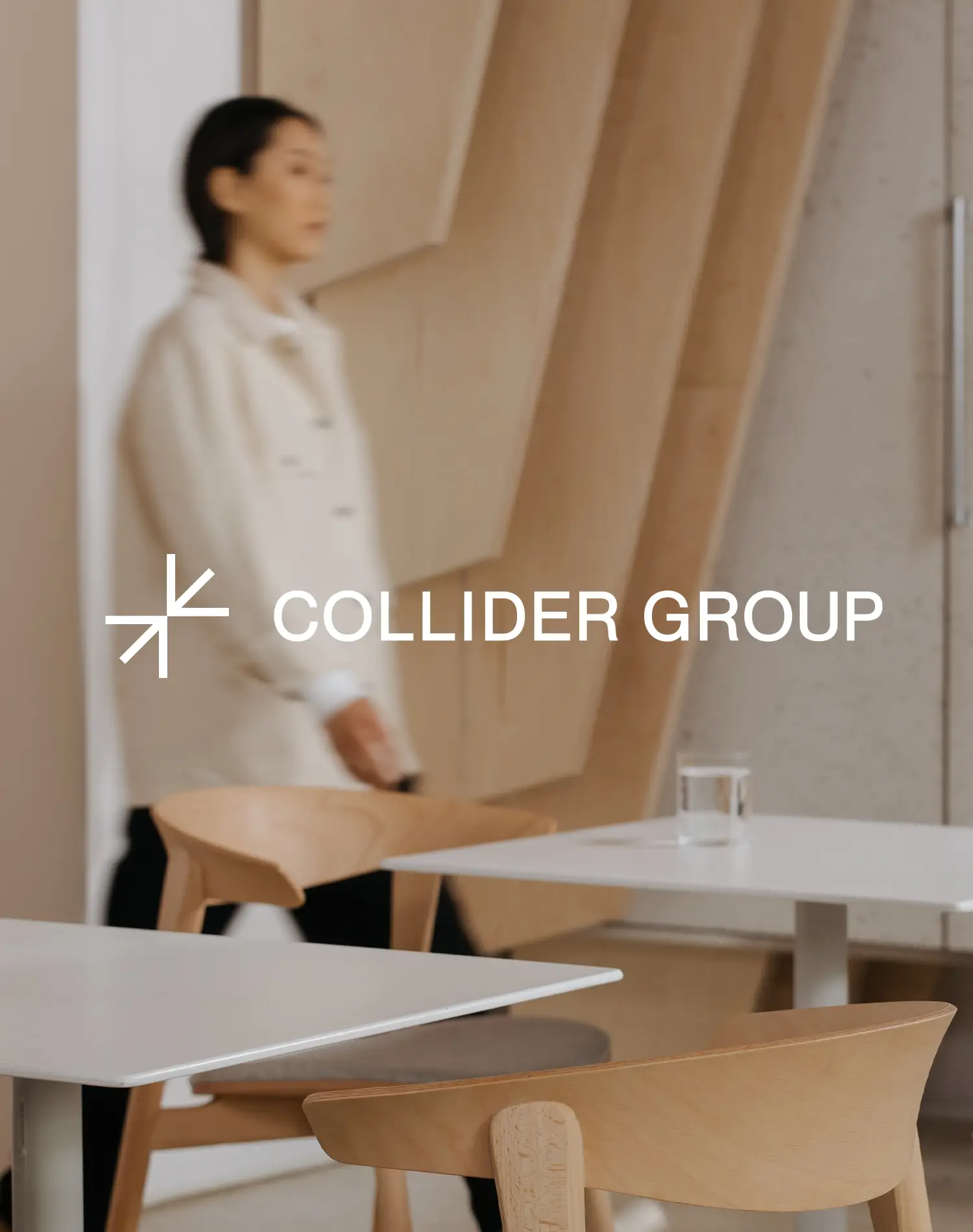Collider Group logo over background image of woman walking in a modern workplace cafe